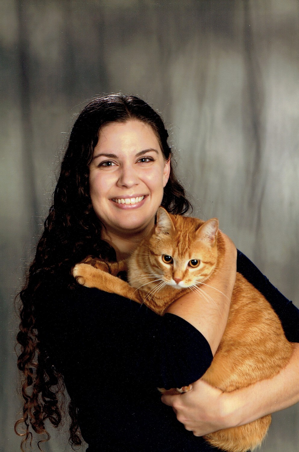 Dr. Laura McCormick DVM holding a yellow cat